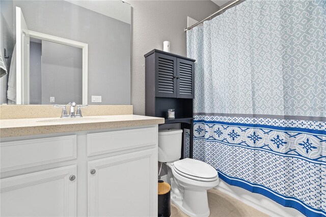 bathroom featuring toilet, a shower with curtain, and vanity