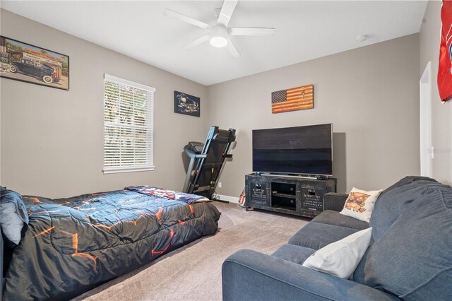 carpeted bedroom with a ceiling fan and baseboards