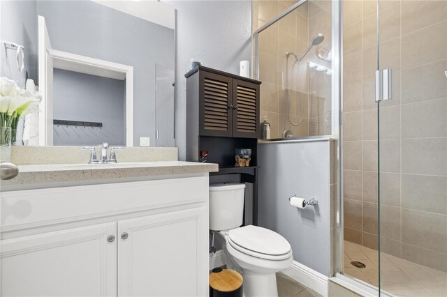 bathroom with a stall shower, vanity, and toilet