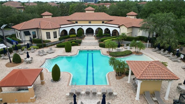 pool with fence and a patio