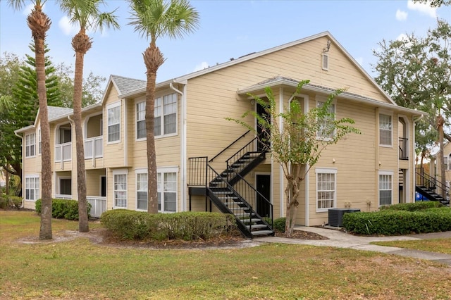 view of front facade with a front yard and central AC unit