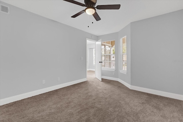 unfurnished room featuring ceiling fan and carpet floors