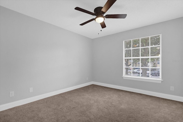 empty room featuring ceiling fan and carpet floors