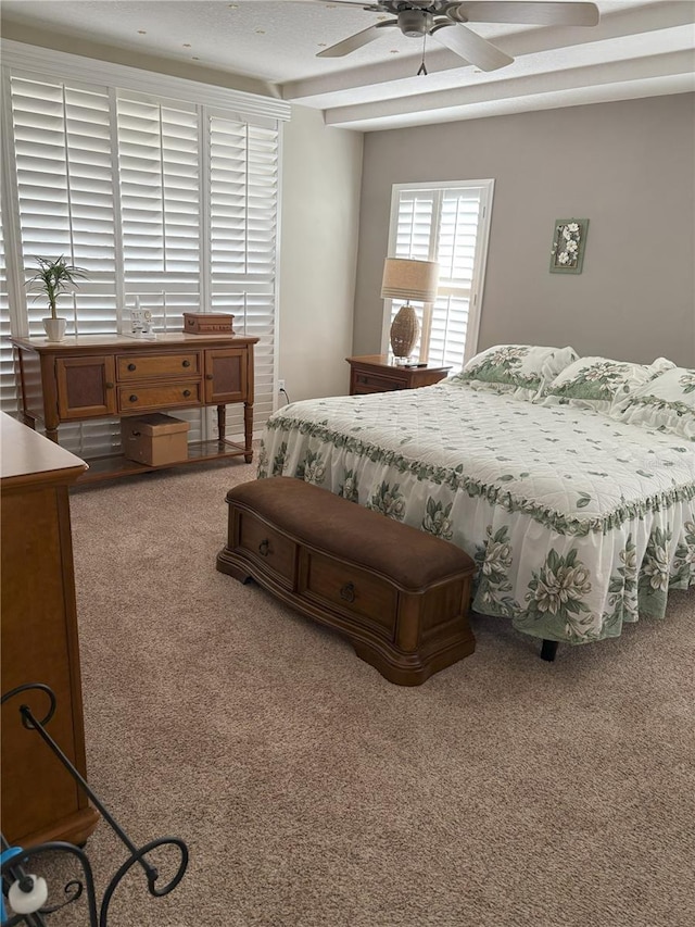 carpeted bedroom featuring beamed ceiling, a textured ceiling, and ceiling fan