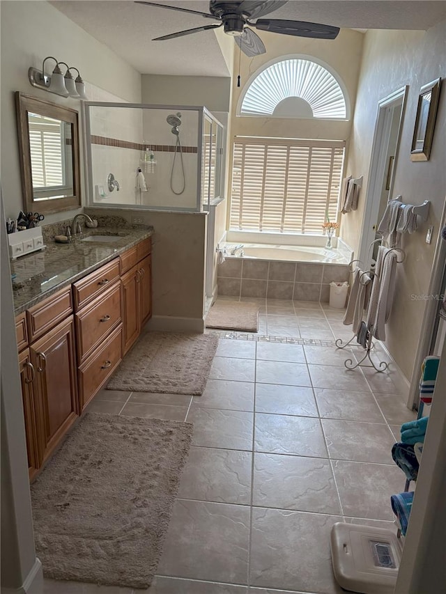 bathroom featuring tile patterned flooring, vanity, ceiling fan, and independent shower and bath