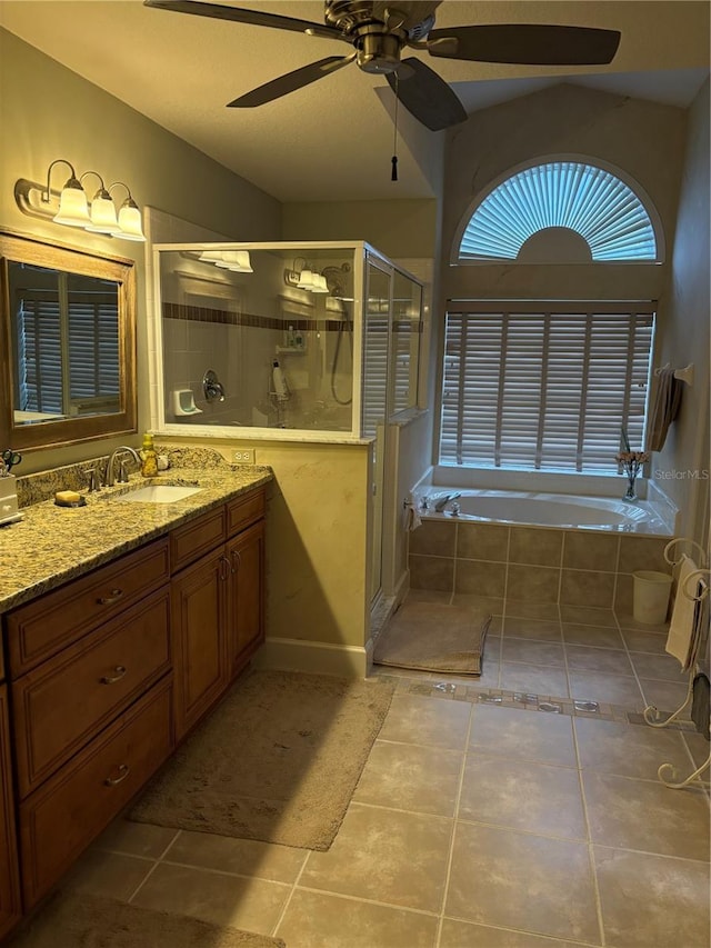 bathroom featuring lofted ceiling, vanity, tile patterned floors, and independent shower and bath