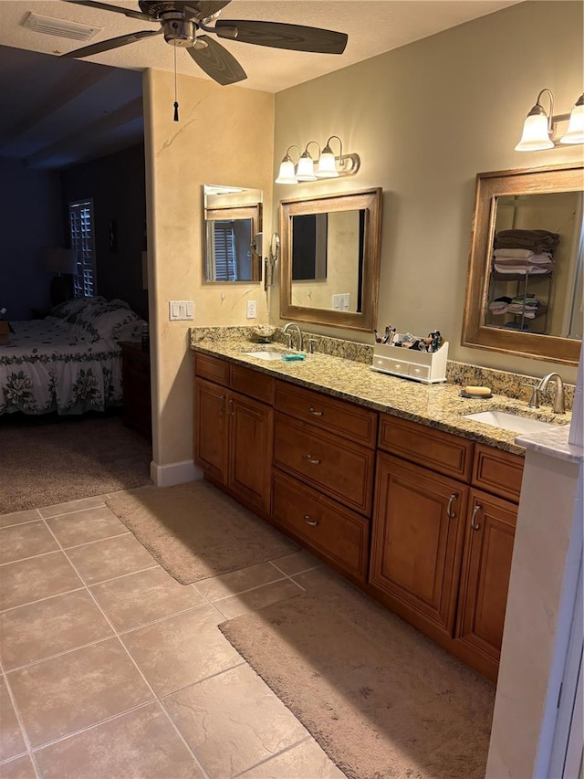 bathroom featuring tile patterned floors, ceiling fan, vanity, and a textured ceiling