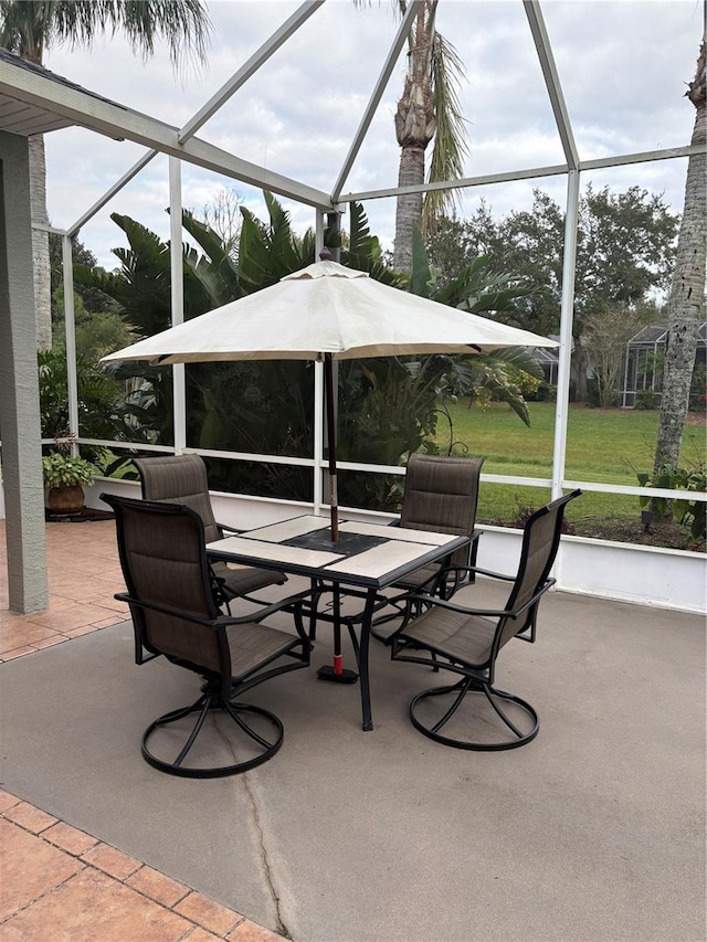 view of patio with glass enclosure