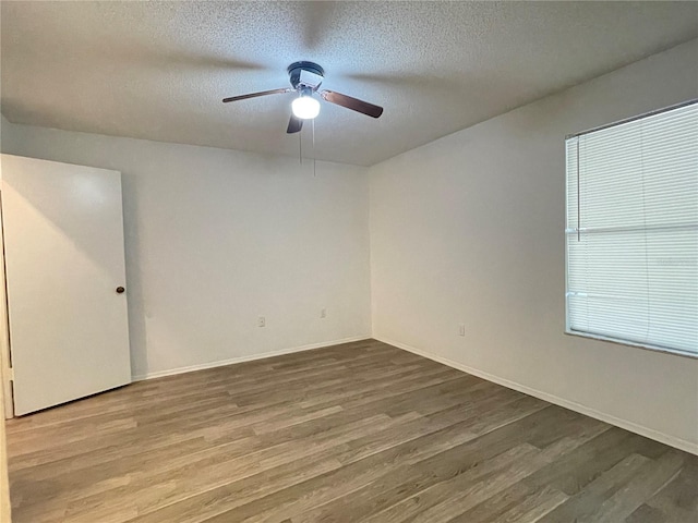 spare room featuring hardwood / wood-style floors, ceiling fan, and a textured ceiling