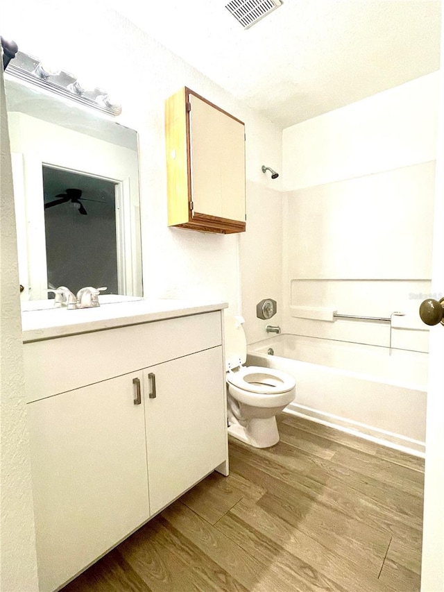 full bathroom featuring shower / tub combination, hardwood / wood-style floors, vanity, and toilet