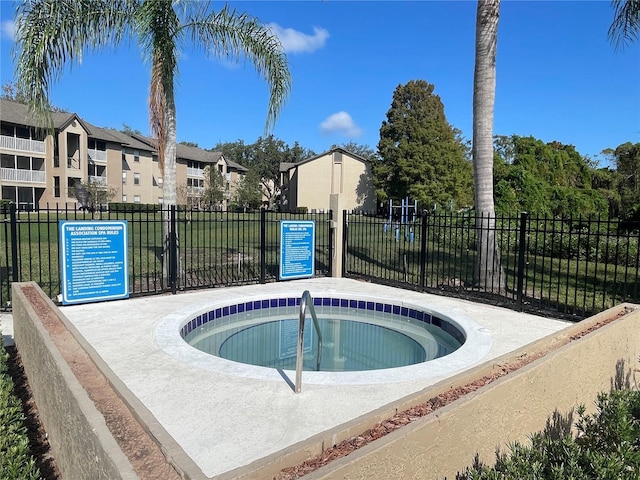 view of swimming pool featuring a community hot tub