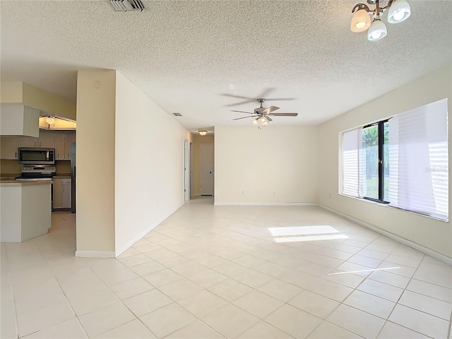 tiled spare room with a textured ceiling and ceiling fan