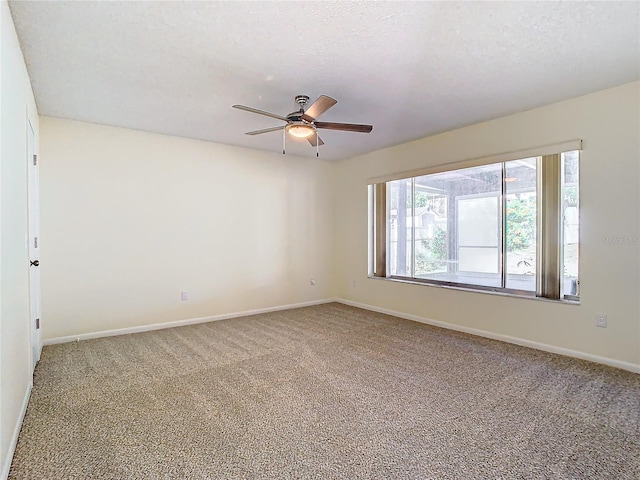 spare room featuring ceiling fan, carpet floors, and a textured ceiling