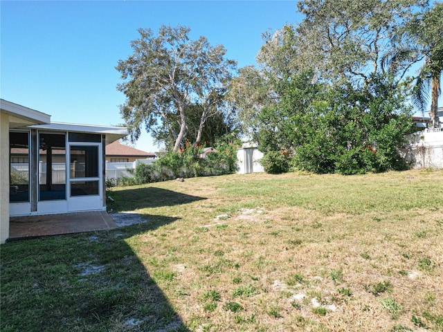 view of yard with a shed and a sunroom