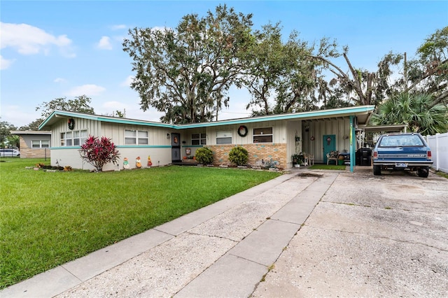 view of front facade with a front yard and a carport