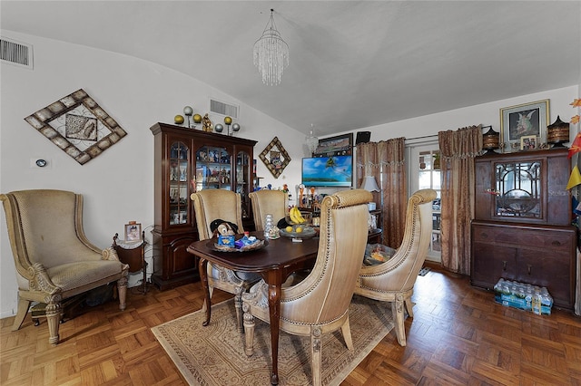 dining area featuring lofted ceiling, parquet flooring, and a chandelier