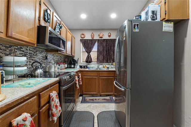 kitchen featuring decorative backsplash, sink, and stainless steel appliances