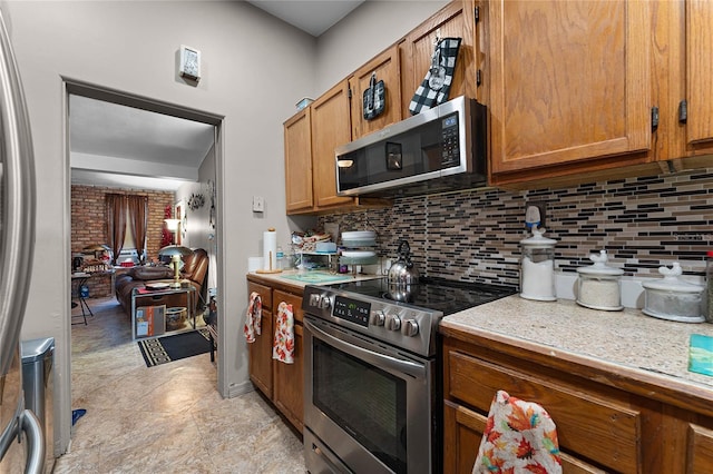 kitchen with backsplash and stainless steel appliances