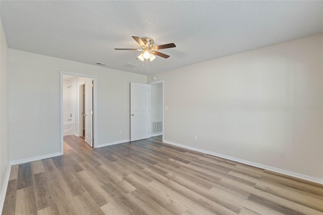 unfurnished bedroom with a textured ceiling, light hardwood / wood-style floors, and ceiling fan