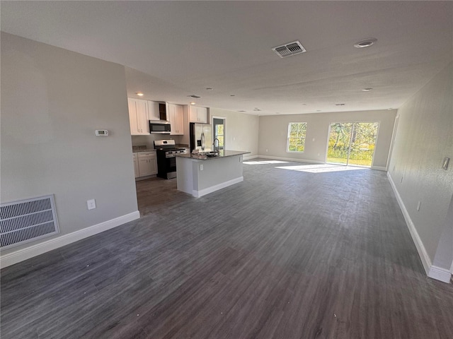 unfurnished living room featuring dark hardwood / wood-style floors