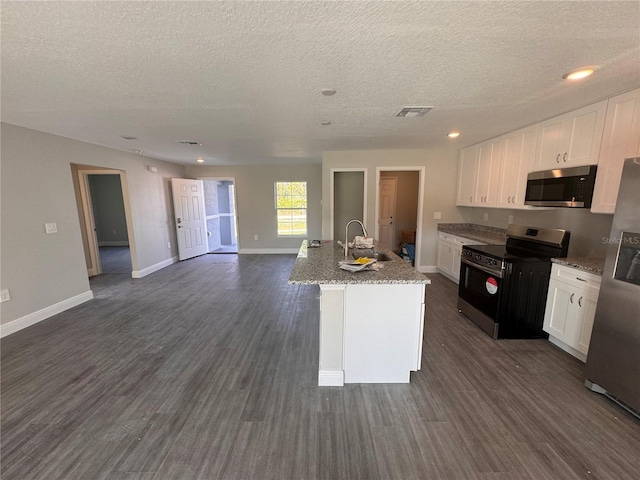 kitchen featuring sink, appliances with stainless steel finishes, dark hardwood / wood-style flooring, a kitchen island with sink, and white cabinets