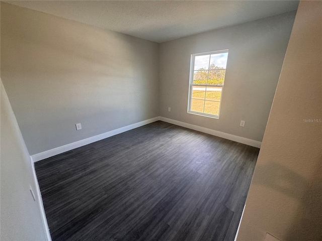 empty room featuring dark hardwood / wood-style floors