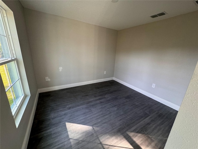 spare room with dark hardwood / wood-style floors