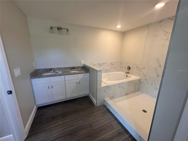 bathroom with hardwood / wood-style flooring, vanity, and independent shower and bath