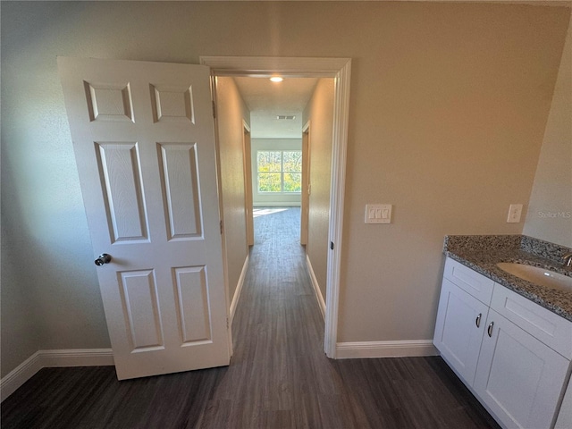 hall with dark wood-type flooring and sink