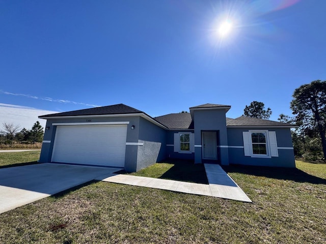 view of front of house with a garage and a front yard