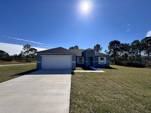 view of front of house featuring a garage and a front lawn