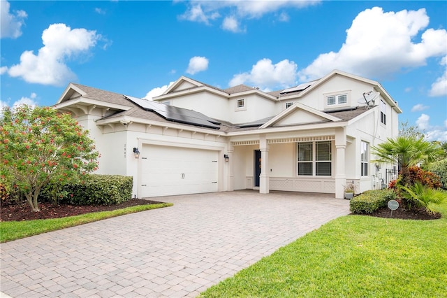 view of front of house featuring a front lawn and a garage