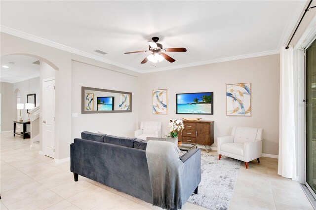 living room featuring ceiling fan, light tile patterned floors, and crown molding