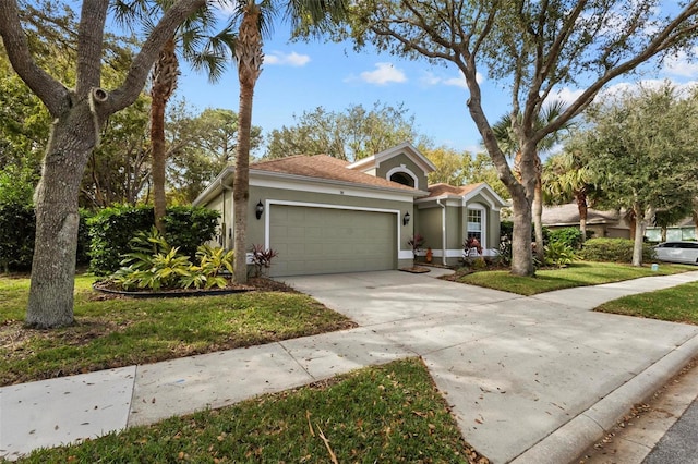 view of front of property featuring a garage and a front lawn