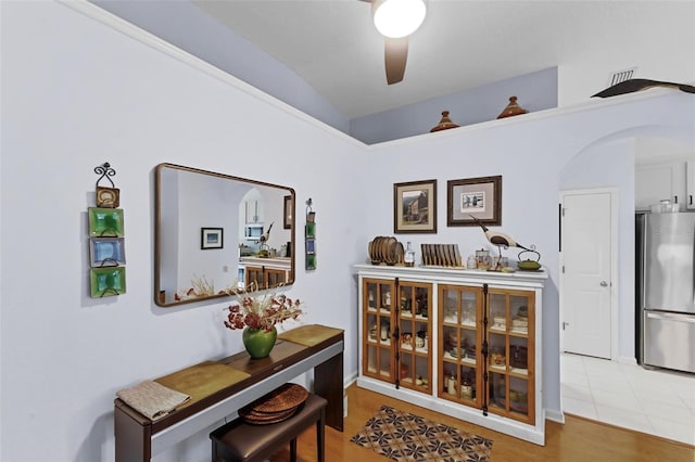 interior space with vaulted ceiling and light tile patterned flooring