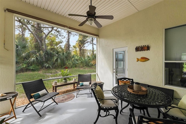 sunroom / solarium featuring ceiling fan and wooden ceiling