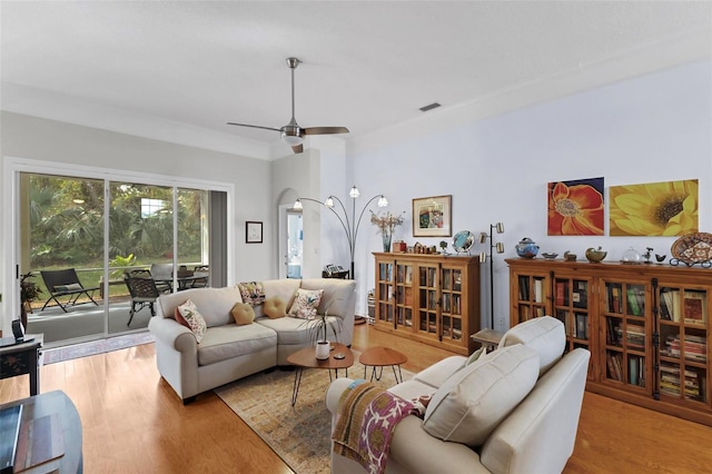 living room with light hardwood / wood-style floors and ceiling fan