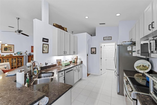 kitchen featuring dishwasher, range, white cabinetry, and sink