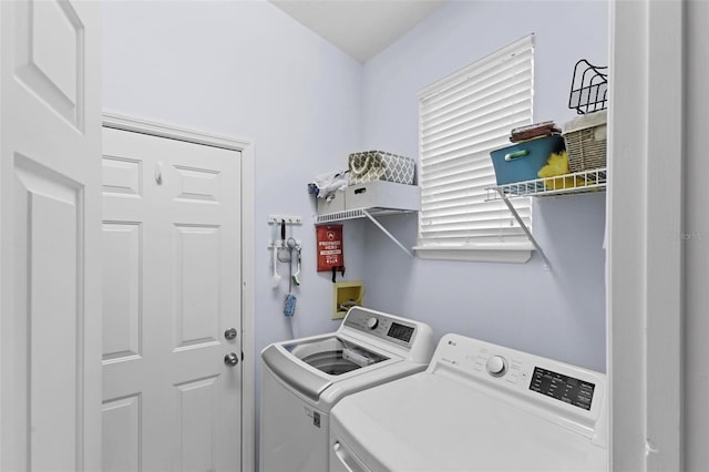 clothes washing area with separate washer and dryer