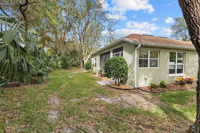 view of side of home featuring a yard