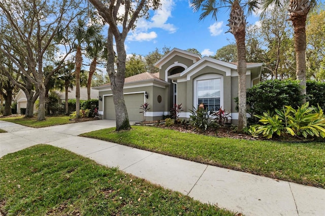 view of front facade with a garage and a front lawn