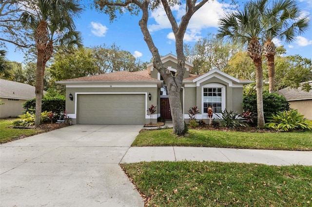 single story home featuring a garage and a front lawn