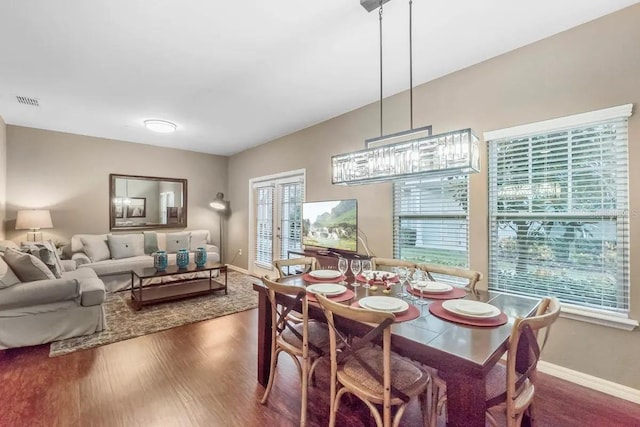 dining area with dark hardwood / wood-style floors and french doors