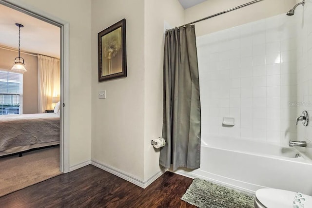 bathroom featuring hardwood / wood-style floors, shower / tub combo, and toilet