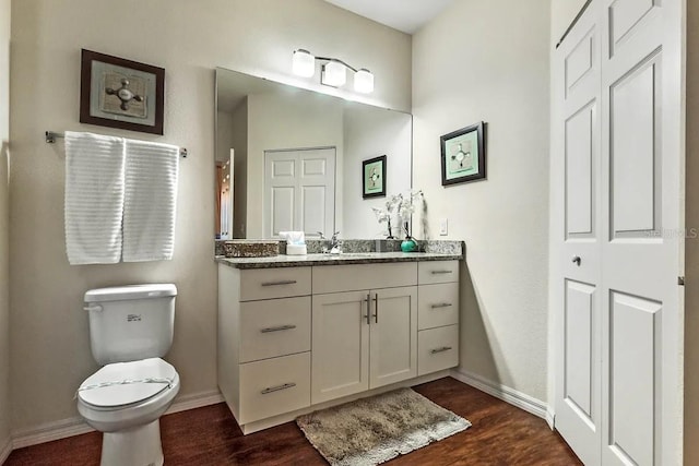 bathroom featuring hardwood / wood-style floors, vanity, and toilet