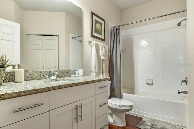 full bathroom featuring shower / bath combo, vanity, hardwood / wood-style flooring, and toilet