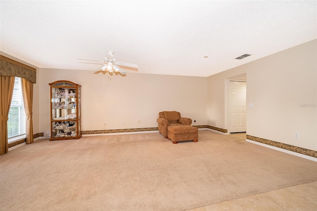 unfurnished room featuring light carpet and ceiling fan