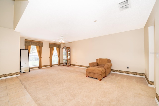 unfurnished room with light carpet and ceiling fan