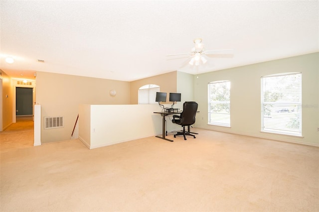 carpeted office featuring ceiling fan