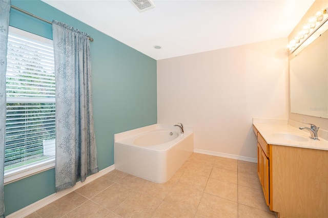 bathroom featuring vanity, tile patterned floors, and a healthy amount of sunlight